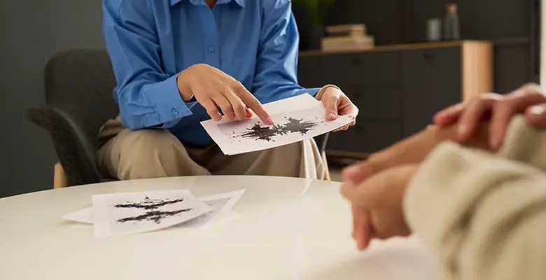 close-up-therapist-pointing-inkblot-test