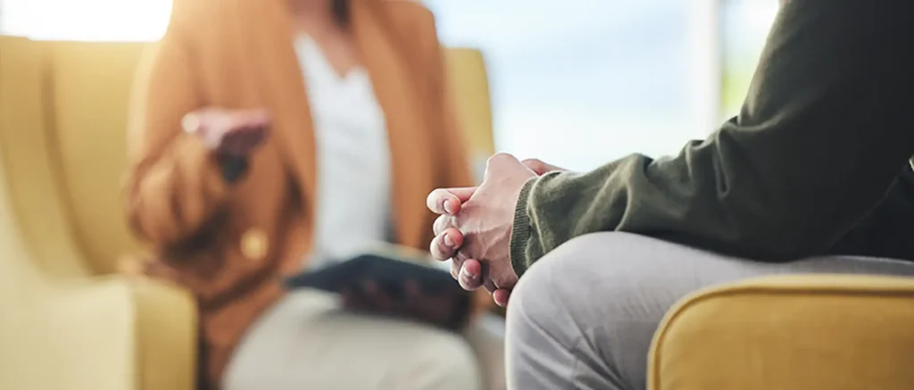 man-hands-listening-therapy-sofa-advice-from-woman-mental-health-psychology-care-psychiatrist-patient-frustrated-clinic-session-couch-help-anxiety-depression
