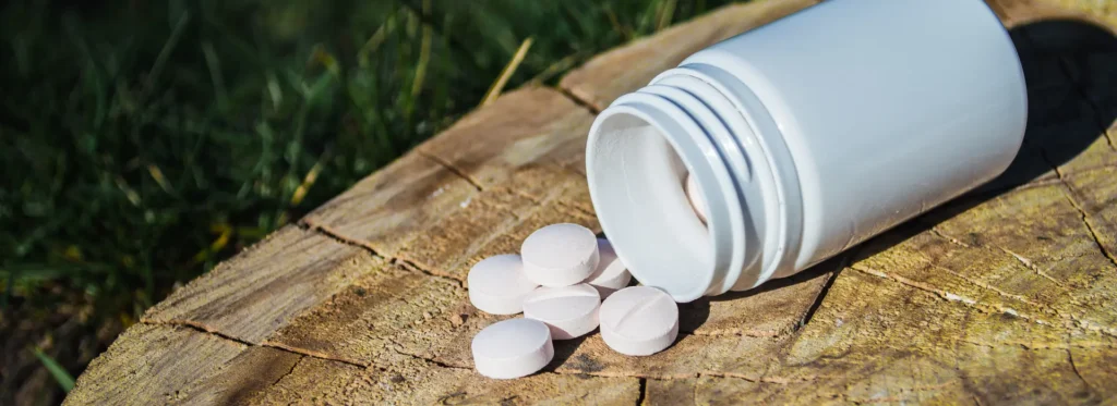 white-jar-white-pills-lie-stump-pills-tablets-closeup-with-bokeh