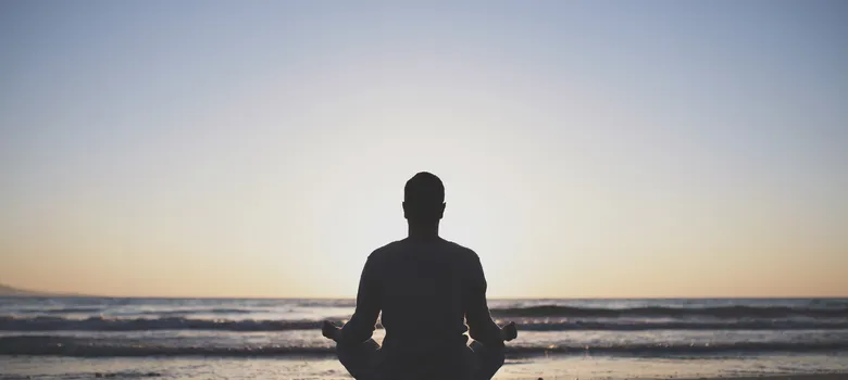 young-man-practice-yoga-beach-sunset