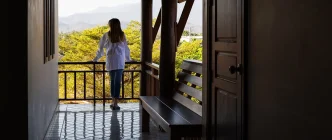 lady standing at terrace looking out to nature